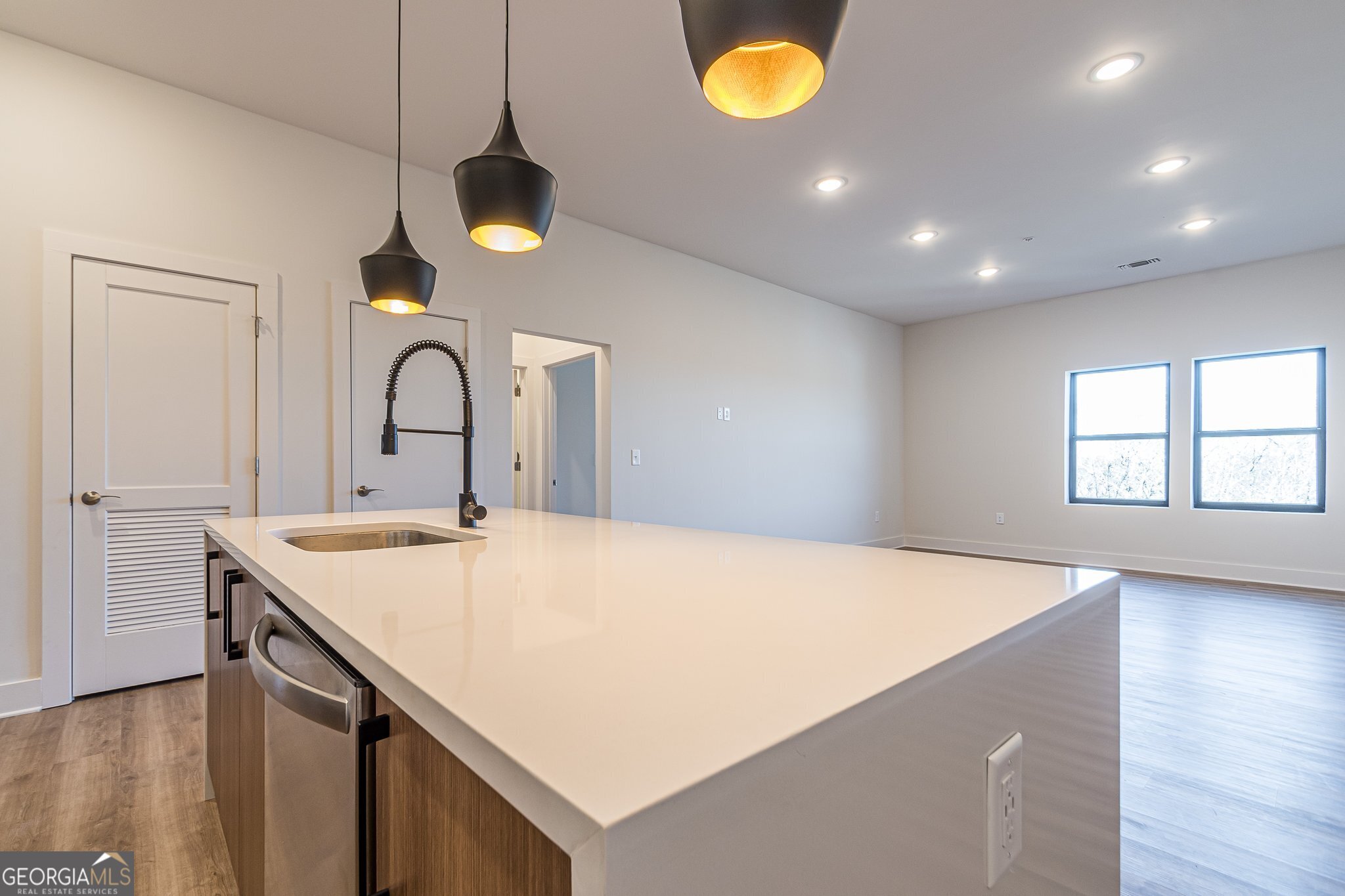 112 Rogers Street Northeast, Unit 601 Atlanta, GA 30317 - Photo 5 of 31 a kitchen with a sink a counter space and wooden floor