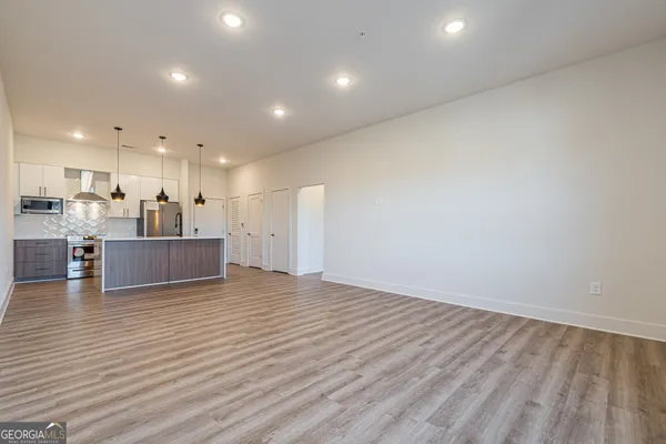 a view of a kitchen with kitchen island and wooden floor