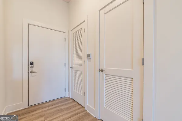 a view of a hallway with wooden floor