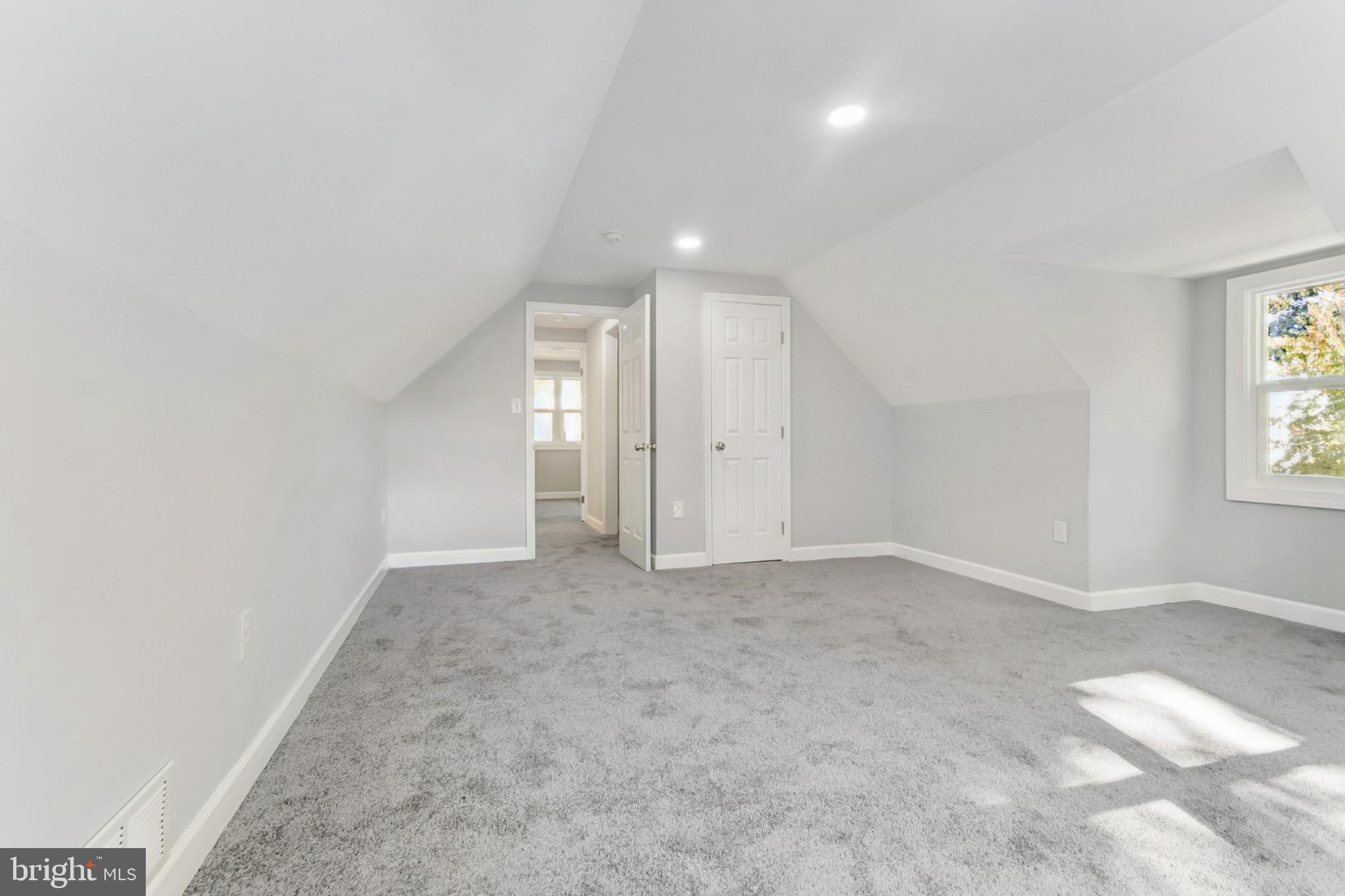 6804 Carol Road Baltimore, MD 21207 - Photo 17 of 25 an empty room with windows and entrance to other room