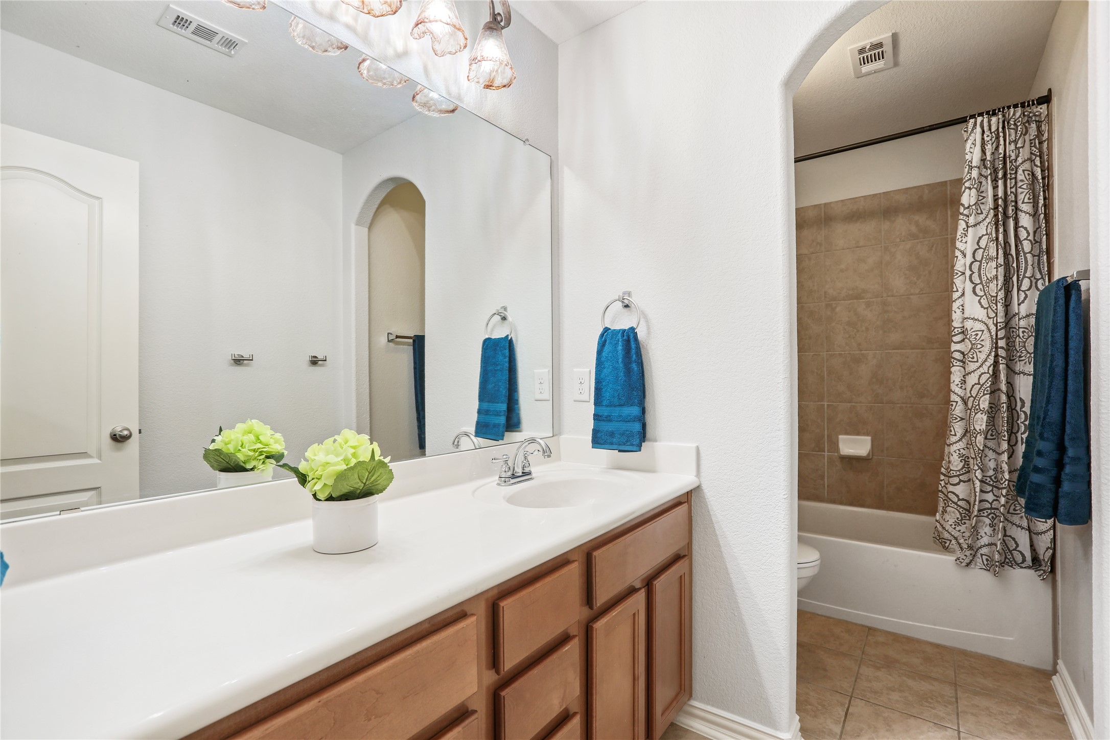 3900 Brean Down Road Pflugerville, TX 78660 - Photo 15 of 35 a bathroom with a granite countertop sink a toilet and shower