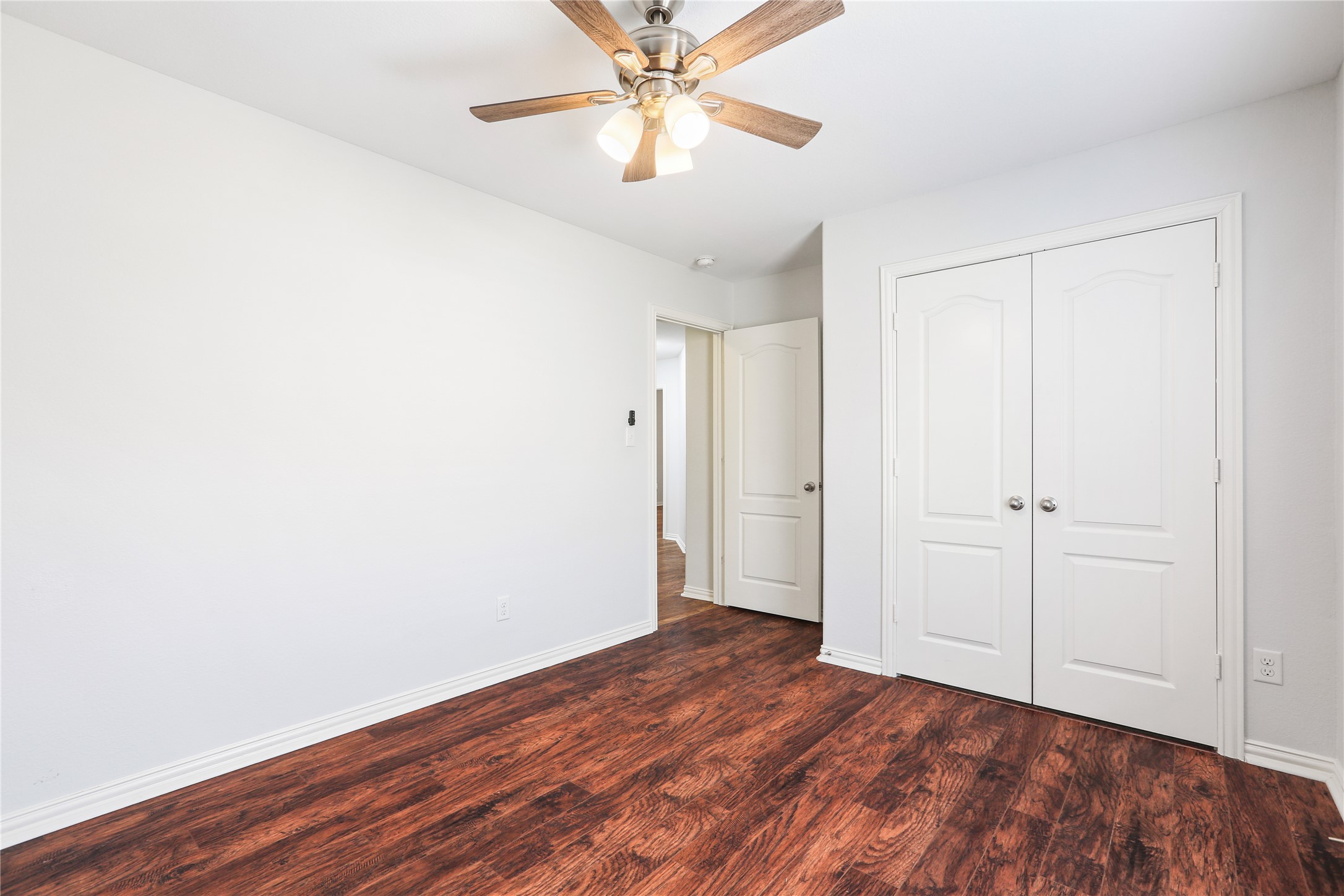 3900 Brean Down Road Pflugerville, TX 78660 - Photo 18 of 35 a view of a room with wooden floor and a ceiling fan