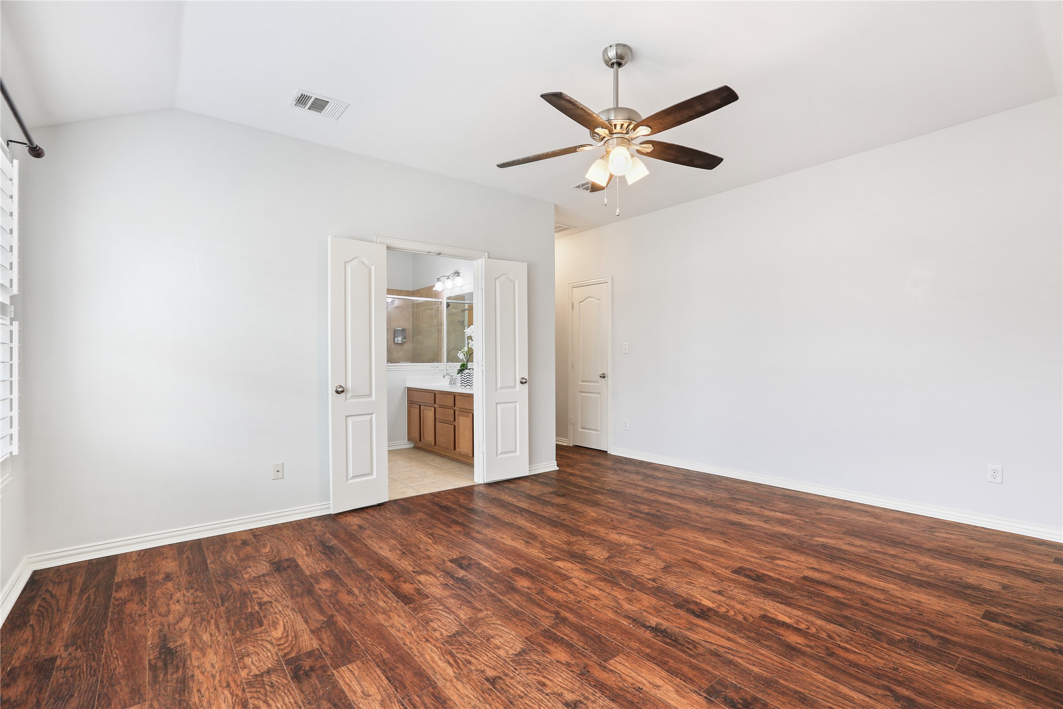 3900 Brean Down Road Pflugerville, TX 78660 - Photo 22 of 35 an empty room with wooden floor fan and windows