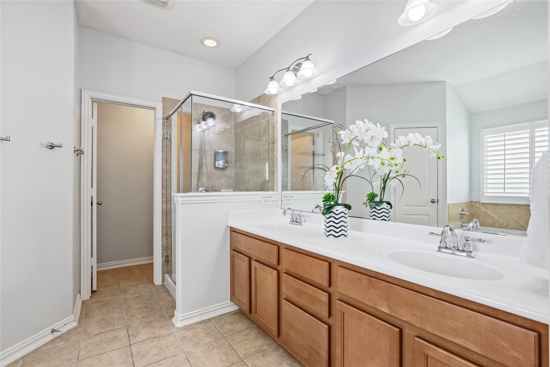 3900 Brean Down Road Pflugerville, TX 78660 - Photo 23 of 35 a bathroom with a sink double vanity and a mirror