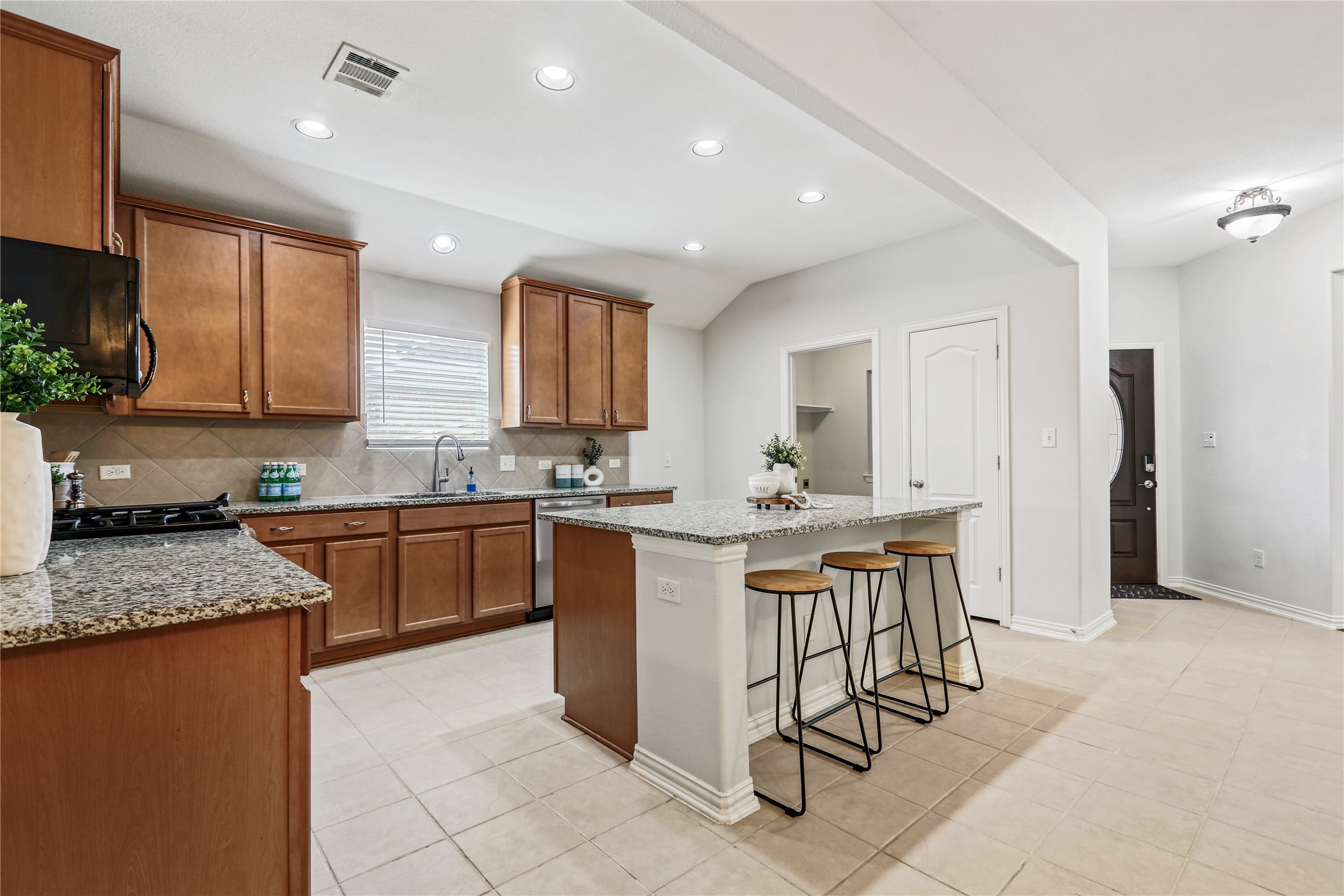 3900 Brean Down Road Pflugerville, TX 78660 - Photo 6 of 35 a kitchen with a sink refrigerator and cabinets