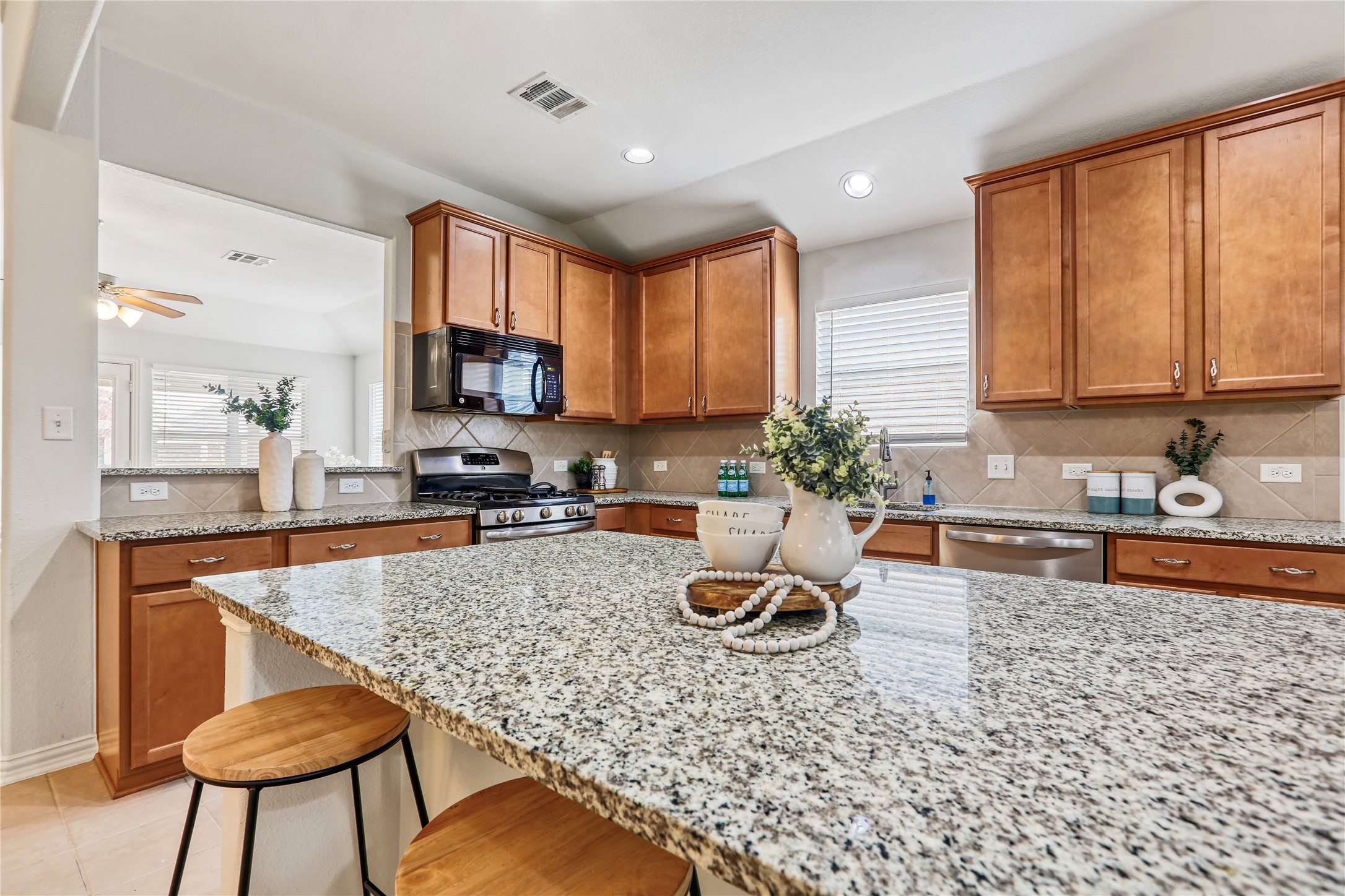 3900 Brean Down Road Pflugerville, TX 78660 - Photo 7 of 35 a kitchen with a stove a sink and a microwave