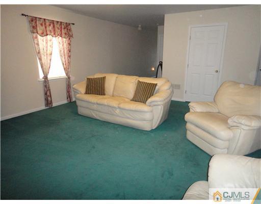 4 Ashley Road Edison, NJ 08817 - Photo 3 of 10 a living room with furniture and a window
