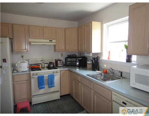 4 Ashley Road Edison, NJ 08817 - Photo 5 of 10 a kitchen with granite countertop a sink dishwasher stove and cabinets