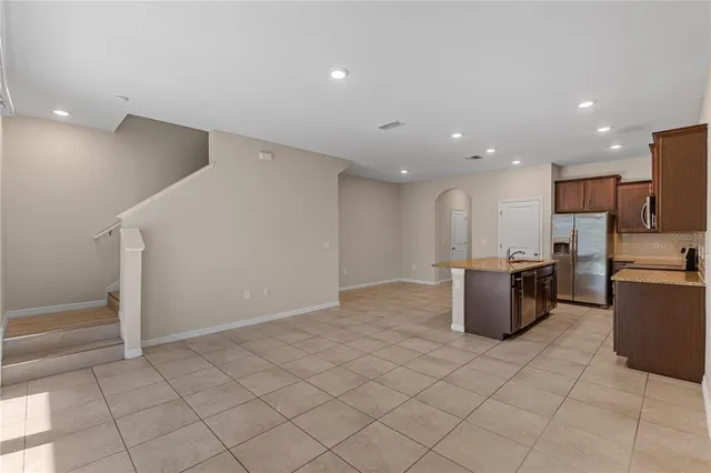a view of kitchen with stainless steel appliances a refrigerator and microwave
