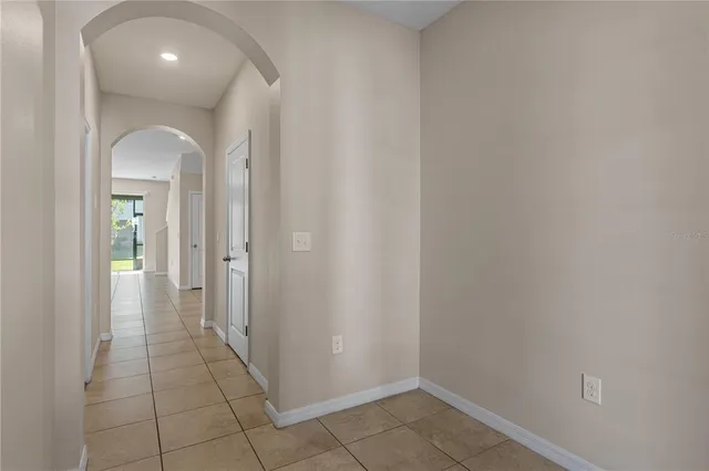a view of a hallway with wooden shelves