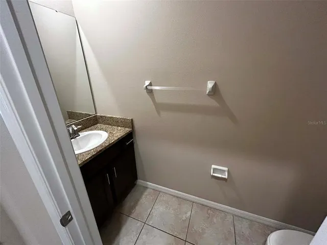 a bathroom with a sink a mirror and toilet