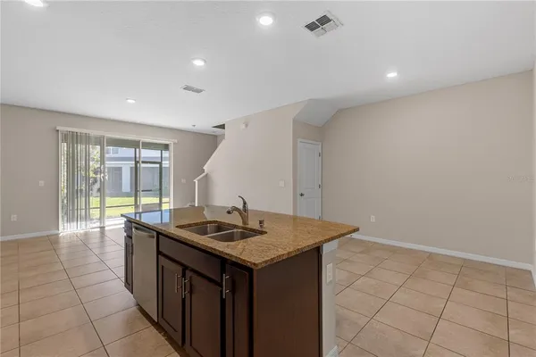 a kitchen that has a sink and a stove in it