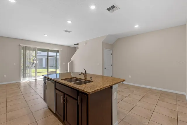 a kitchen that has a sink and a stove in it