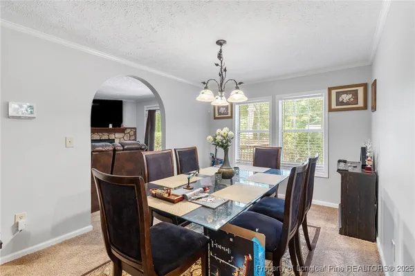 a view of a dining room with furniture window and outside view