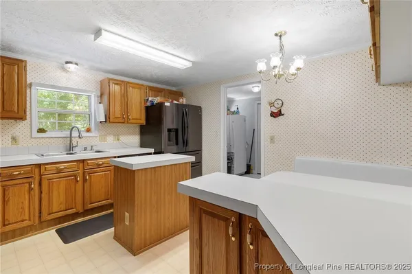 a kitchen with a sink and refrigerator
