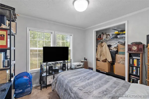 a bedroom with furniture and a flat screen tv