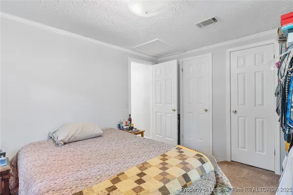 a bedroom with a bed and a closet