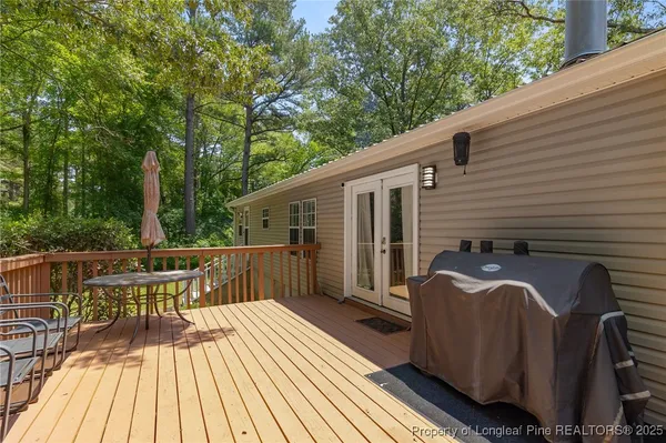 a view of a balcony with two chairs and wooden floor