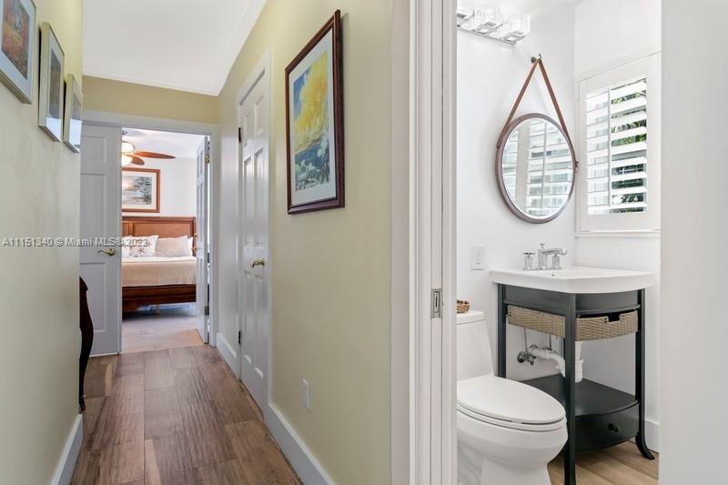 710 Woodcrest Road Key Biscayne, FL 33149 - Photo 16 of 34 a bathroom with a toilet a sink and a mirror