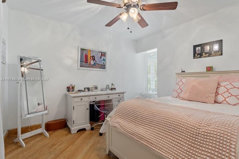 710 Woodcrest Road Key Biscayne, FL 33149 - Photo 20 of 34 a bedroom with a bed and a chandelier