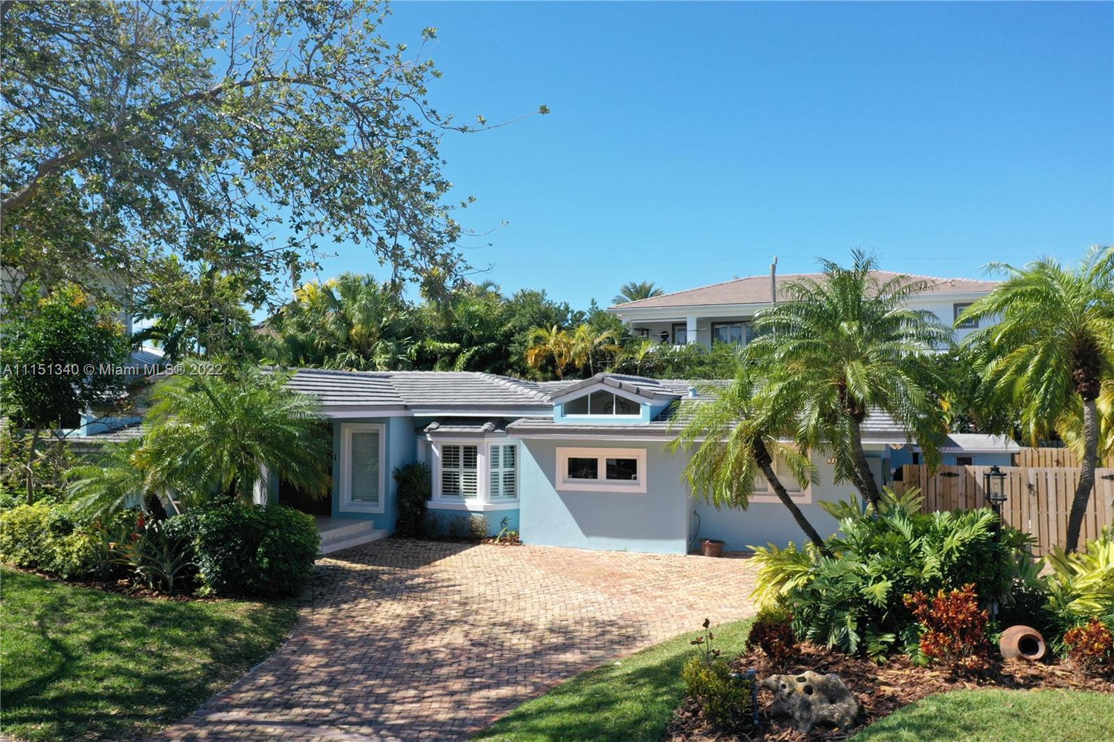 710 Woodcrest Road Key Biscayne, FL 33149 - Photo 2 of 34 a front view of a house with a garden