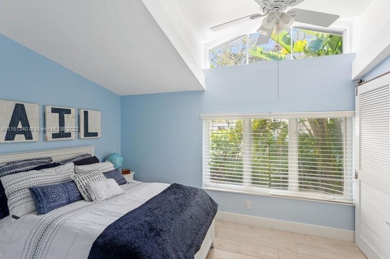 710 Woodcrest Road Key Biscayne, FL 33149 - Photo 21 of 34 a bedroom with a bed and a window