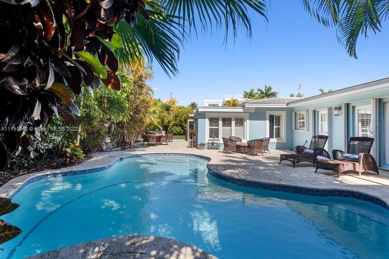710 Woodcrest Road Key Biscayne, FL 33149 - Photo 25 of 34 a view of a house with swimming pool and sitting area