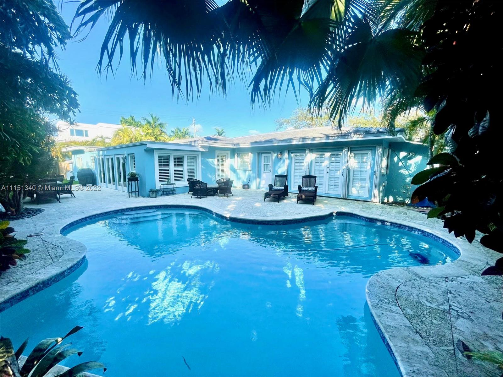 710 Woodcrest Road Key Biscayne, FL 33149 - Photo 26 of 34 a view of a house with swimming pool and sitting area