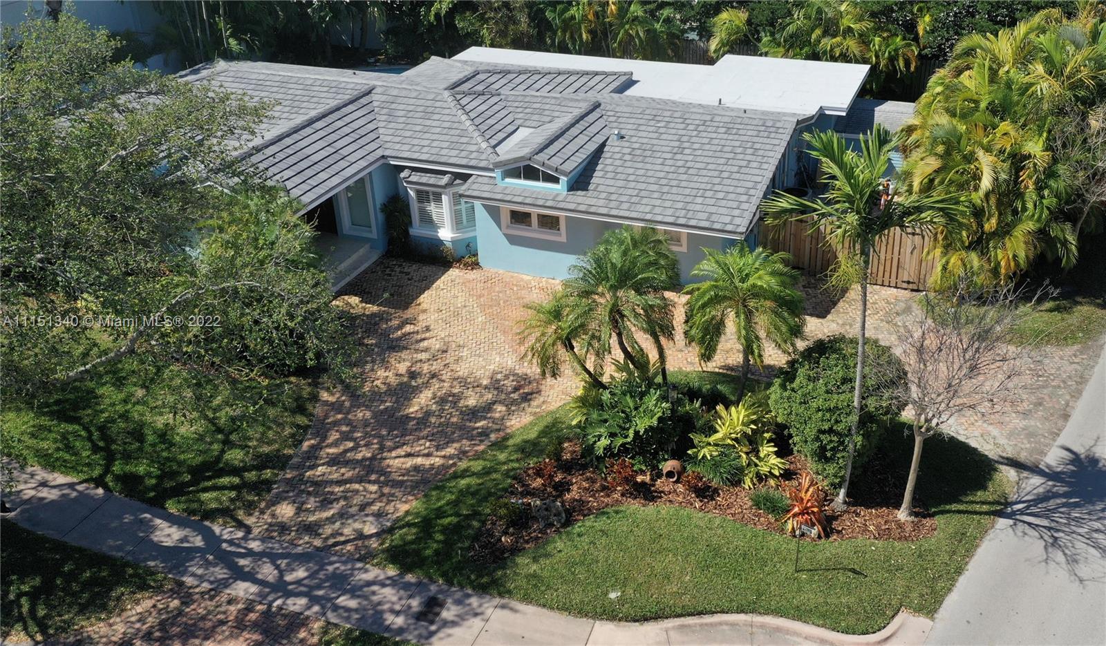 710 Woodcrest Road Key Biscayne, FL 33149 - Photo 30 of 34 a aerial view of a house with a yard and potted plants
