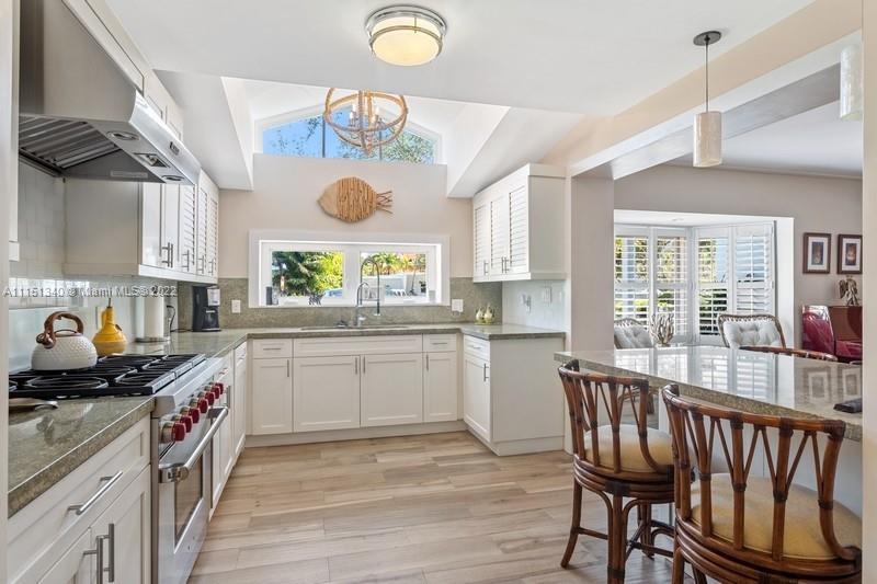 710 Woodcrest Road Key Biscayne, FL 33149 - Photo 7 of 34 a kitchen with a window a sink and a stove