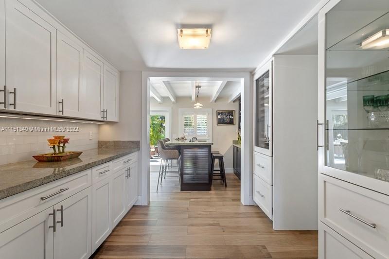 710 Woodcrest Road Key Biscayne, FL 33149 - Photo 8 of 34 a kitchen with stainless steel appliances granite countertop a refrigerator and cabinets