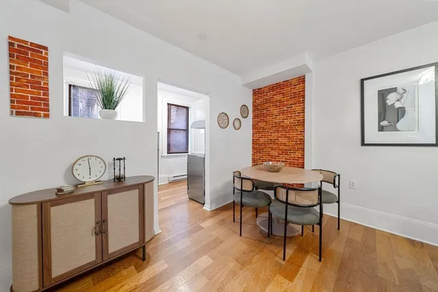a dining room with furniture and wooden floor