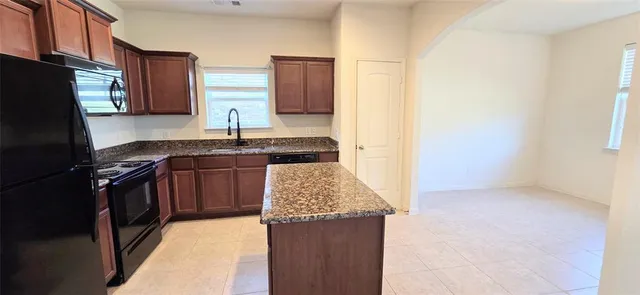 a kitchen with a sink stove and refrigerator