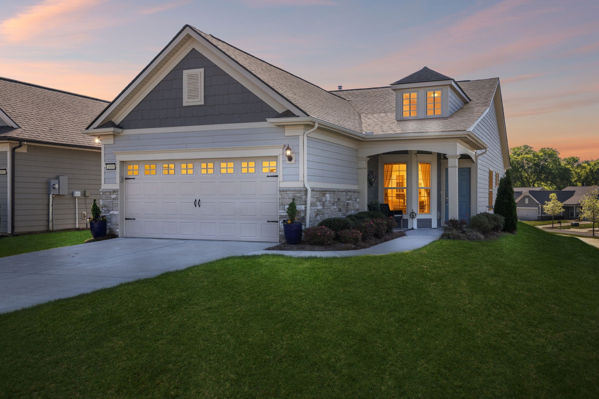 a front view of a house with a yard and garage
