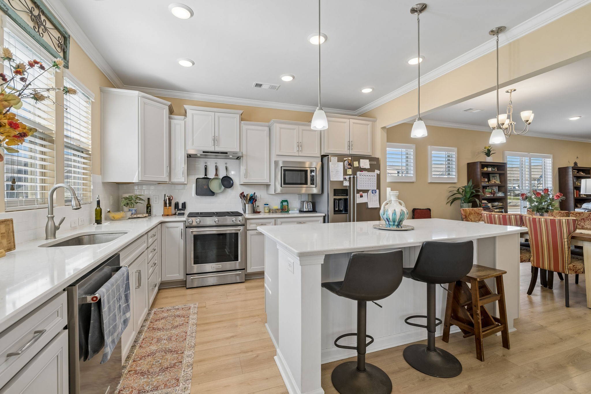 1600 Grainger Springs Spring Hill, TN 37174 - Photo 15 of 26 a kitchen with stainless steel appliances granite countertop a table chairs sink and cabinets