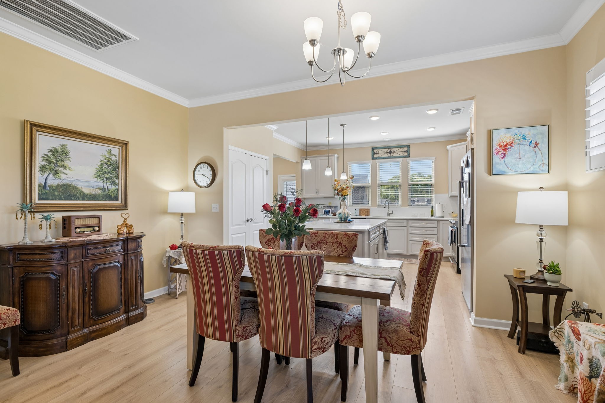 1600 Grainger Springs Spring Hill, TN 37174 - Photo 9 of 26 a view of a dining room with furniture a chandelier and wooden floor