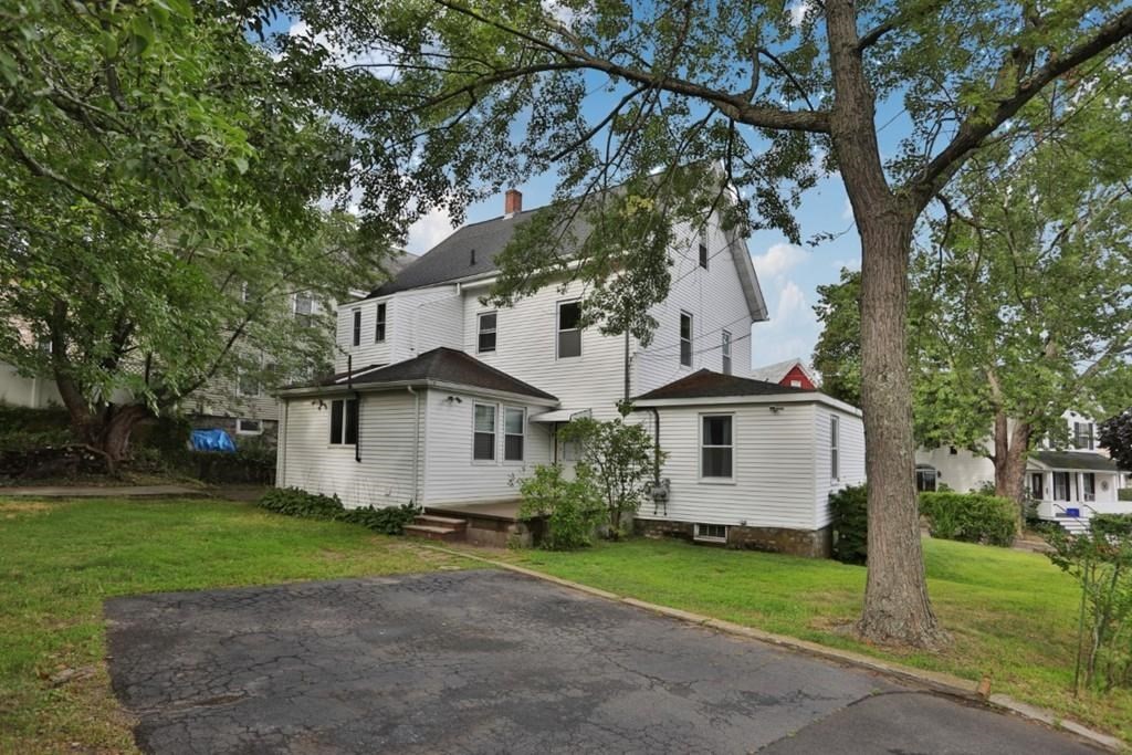 41 Baker Street, Unit 41 Malden, MA 02148 - Photo 3 of 11 a white house that has a tree in front of the house