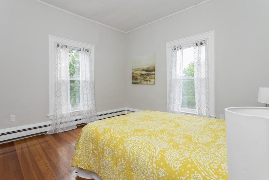 41 Baker Street, Unit 41 Malden, MA 02148 - Photo 7 of 11 a bed sitting in a bedroom next to a window