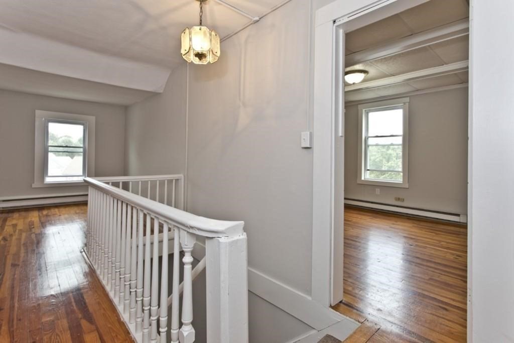 41 Baker Street, Unit 41 Malden, MA 02148 - Photo 9 of 11 a view of a hallway with wooden floor and staircase