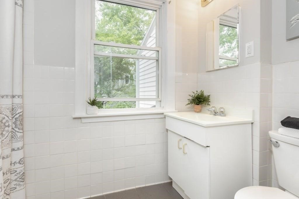 41 Baker Street, Unit 41 Malden, MA 02148 - Photo 10 of 11 a bathroom with a sink a toilet and a window