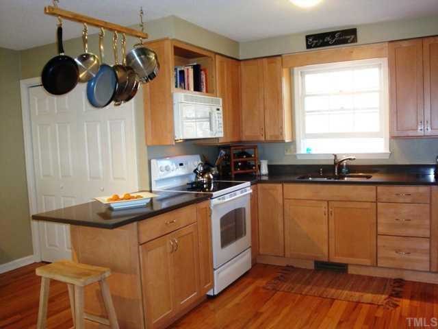 5912 Rondan Circle Raleigh, NC 27612 - Photo 4 of 12 a kitchen with a sink and cabinets