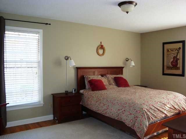 5912 Rondan Circle Raleigh, NC 27612 - Photo 8 of 12 a bedroom with a bed and a window
