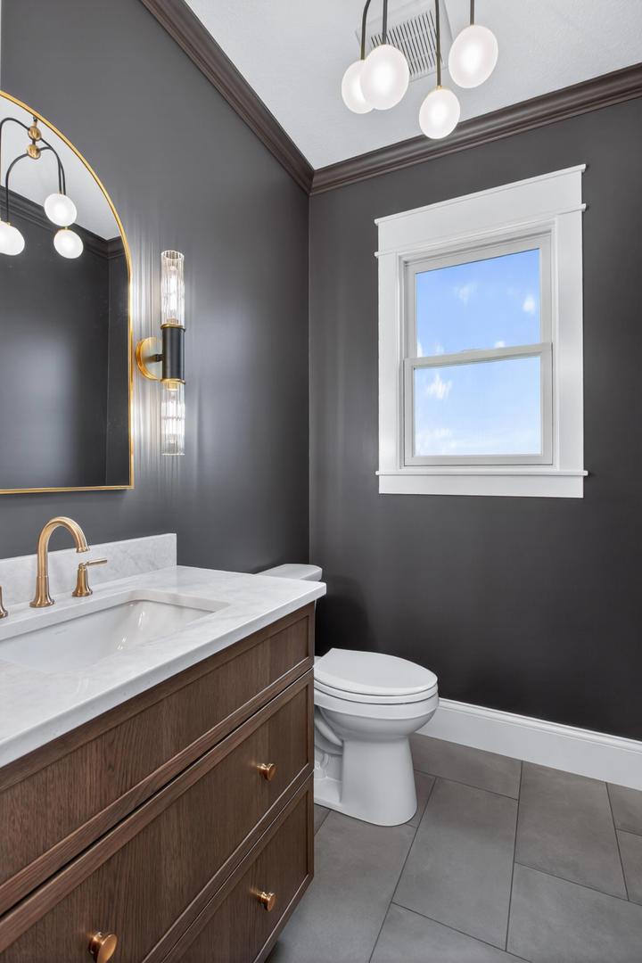 6928 Wilderness Pointe Bettendorf, IA 52722 - Photo 26 of 48 a bathroom with a toilet sink and mirror