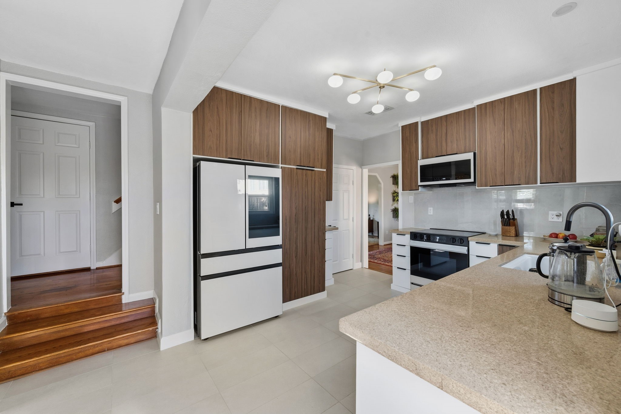 1831 Palm Street Houston, TX 77004 - Photo 9 of 27 Recently renovated modern kitchen with sleek wooden soft-close cabinetry, new Bespoke appliances, quartz counters, and ample counter space.