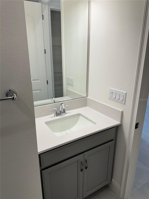 5282 Buttonsage Drive St. Cloud, FL 34772 - Photo 14 of 43 a bathroom with a sink and a mirror
