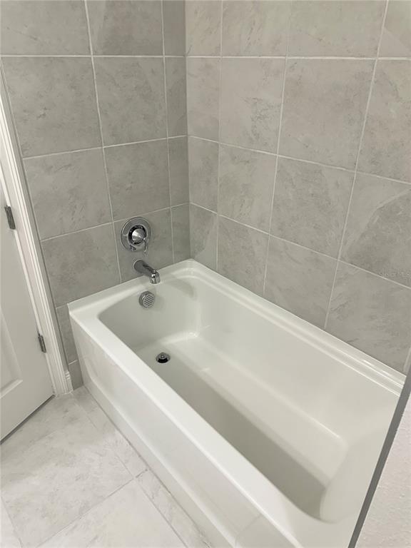 5282 Buttonsage Drive St. Cloud, FL 34772 - Photo 15 of 43 a white bath tub and a shower