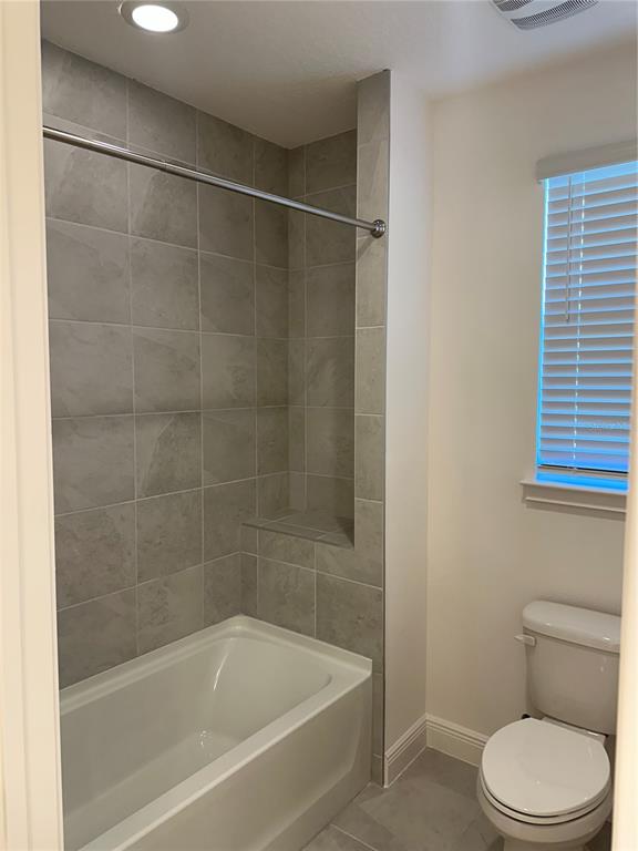 5282 Buttonsage Drive St. Cloud, FL 34772 - Photo 24 of 43 a bath room with a toilet and a bath tub