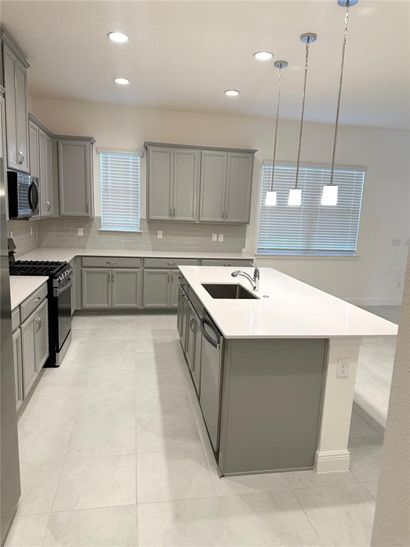 5282 Buttonsage Drive St. Cloud, FL 34772 - Photo 3 of 43 a kitchen with a sink a counter top space stainless steel appliances and cabinets