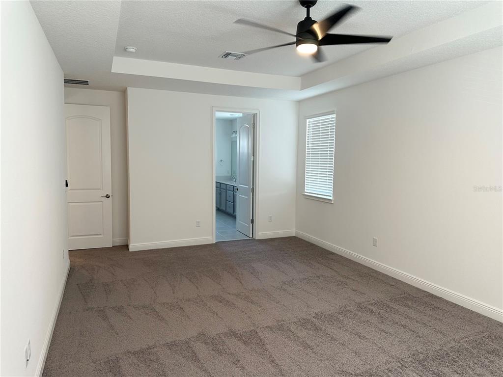 5282 Buttonsage Drive St. Cloud, FL 34772 - Photo 32 of 43 an empty room with windows and fan
