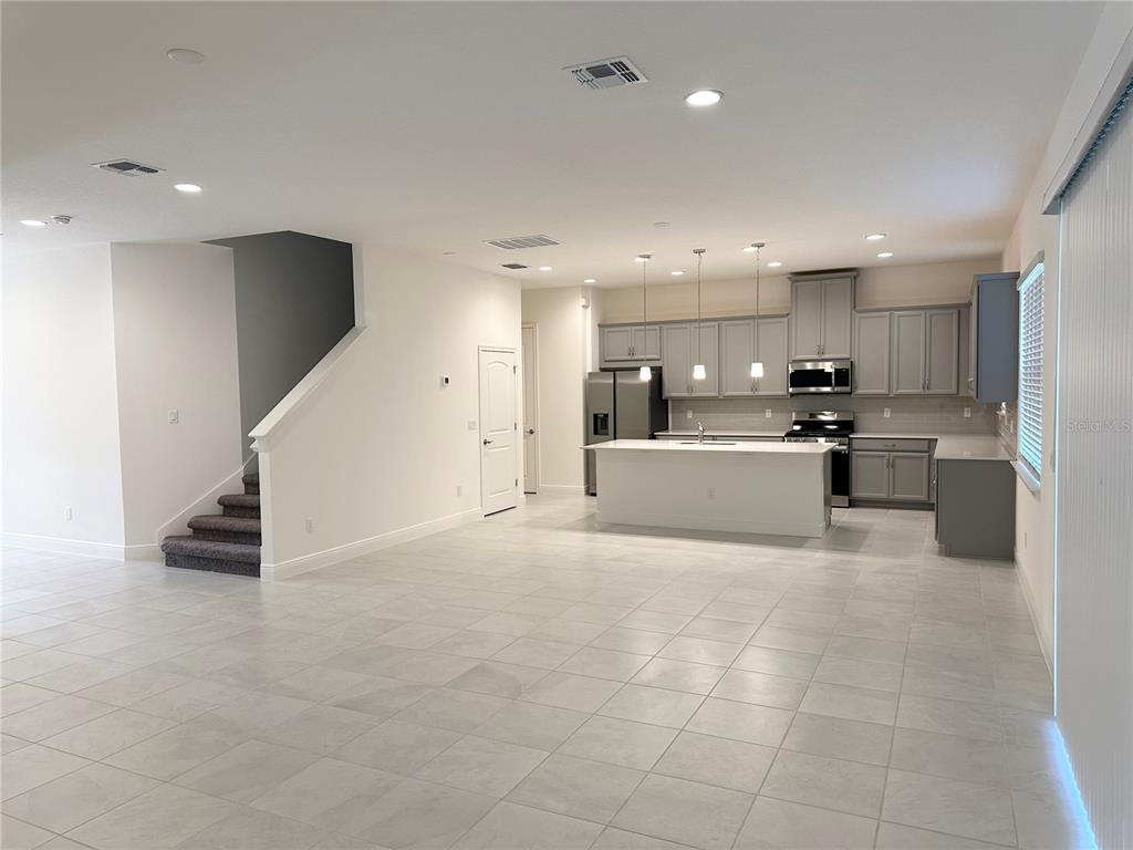 5282 Buttonsage Drive St. Cloud, FL 34772 - Photo 7 of 43 a view of kitchen with kitchen island white cabinets and refrigerator